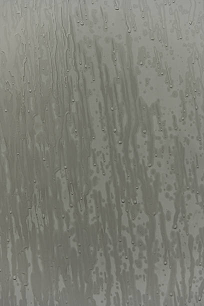 istock Gray metal surface filled with rainwater drops 2240177609