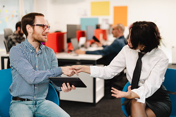 istock Businesspeople engaged in a productive discussion while shaking hands in a modern office setting during a collaborative meeting 2240177697