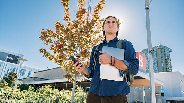 istock Young male student  at the college exterior 2240179743