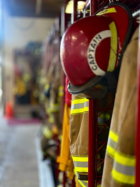 istock Closeup Focus on Foreground Defocused Background Firefighting Turnout Gear Hanging in Fire Station 2240179974