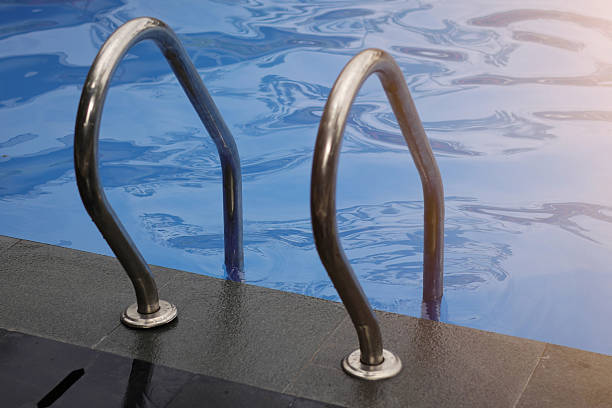 istock Close up Ladder stainless handrails (stairs) into the swimming pool 2240181703