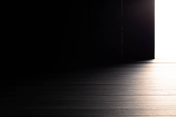 istock Black wooden floor or empty table with light coming from behind, warm atmosphere, on a black and dark background. 2240182426