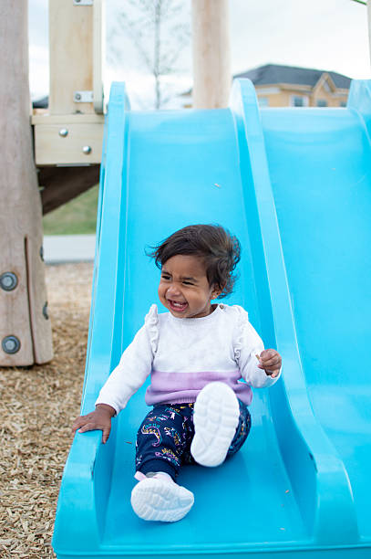 istock Little Girl Playing on a Slide in the Park. 2240186253