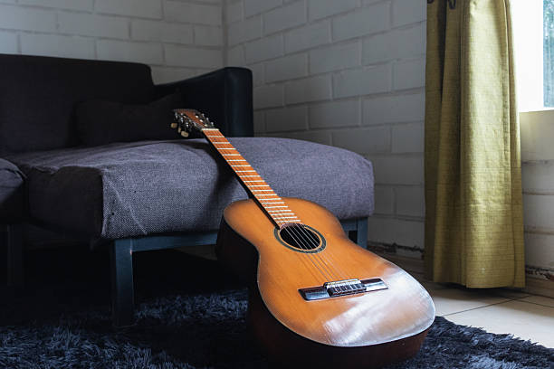 istock an acoustic guitar on the sofa 2240186476