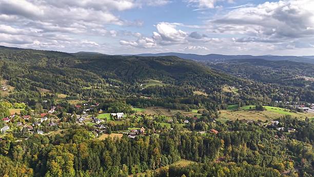A stunning aerial view captures the scenic mountain landscape adorned with lush greenery