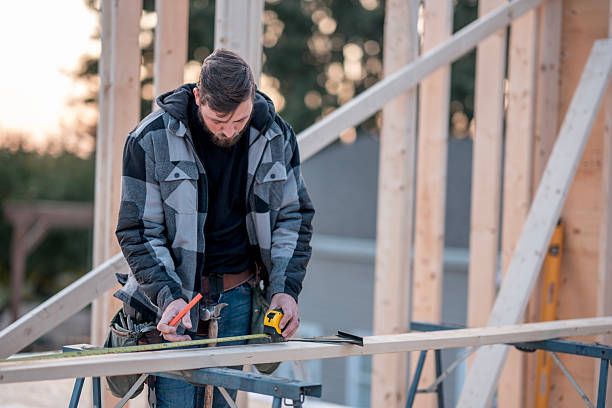 istock Construction Worker Measuring Wooden Beam On Frame During Building Project Outdoors 2240189963