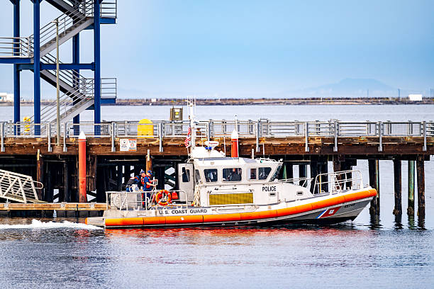 Port Angeles WA, USA - September 6, 2025:  A United States Coast Guard boat crew towed a stranded sailor and his sailboat into Port Angeles and docked it at the pier.