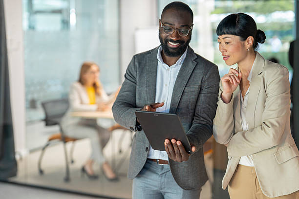 istock Business colleagues collaborating on digital tablet in modern office 2240196307