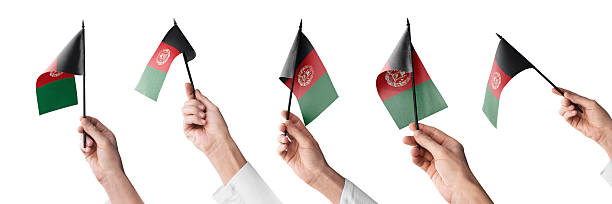 The Afghanistan flag in hand in different angles on a white background.