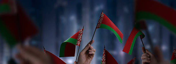 istock Belarus flags in their hands on a blurred urban background 2240206157