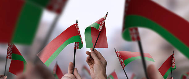 istock Belarus flags in their hands on a blurred urban background 2240206168