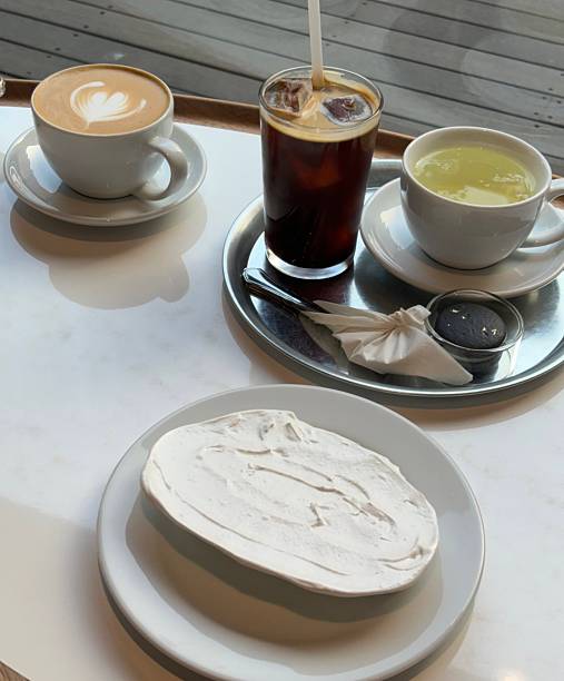 A delightful assortment of desserts displayed in a cozy cafe setting, featuring cakes, pastries, and sweet treats on elegant plates, creating a warm and inviting atmosphere.