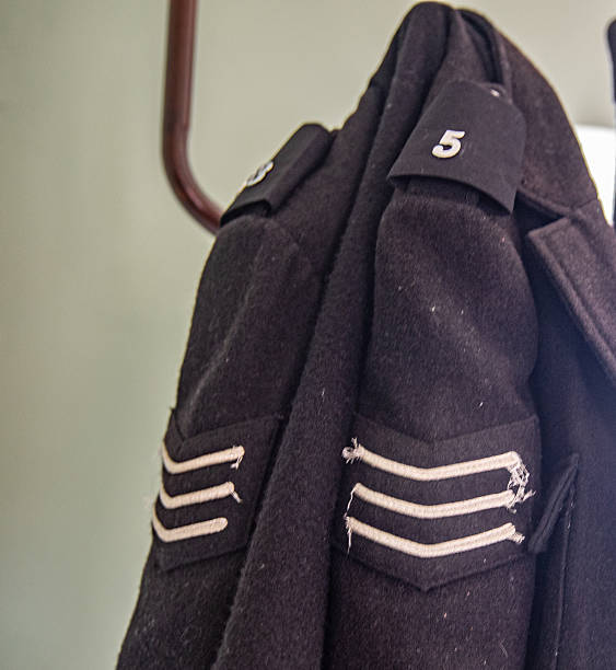 Old style Police uniform jacket  hanging on a clothes peg  - Law and enforcement and security - bygone age of Police houses - policing in the community