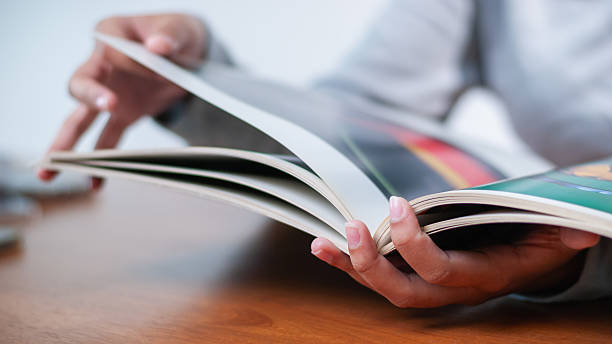 istock Exploring creative ideas in a magazine cozy workspace print media warm lighting close-up view inspiration 2240207151