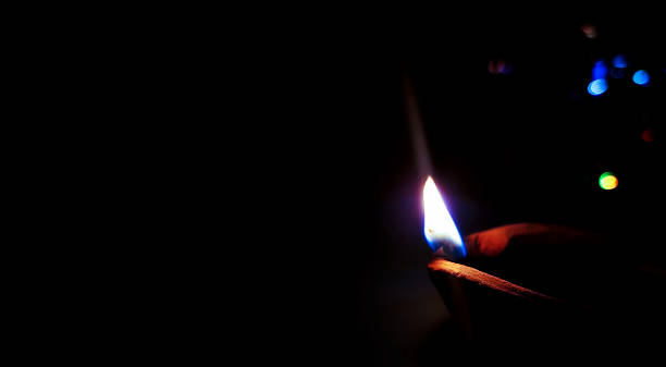 istock Single Clay Oil Lamp Glowing in Darkness 2240209848