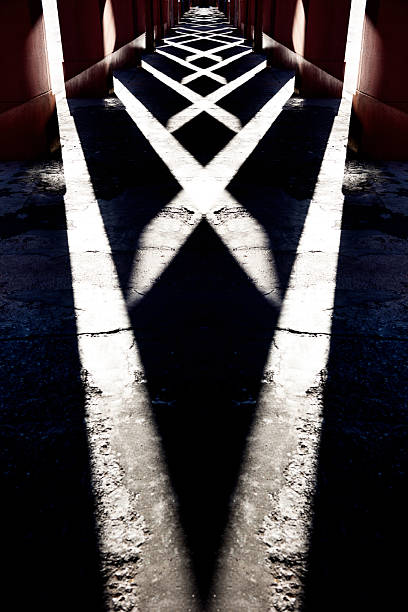 Abstract background of high contrast sunlight and shadows on a concrete floor.