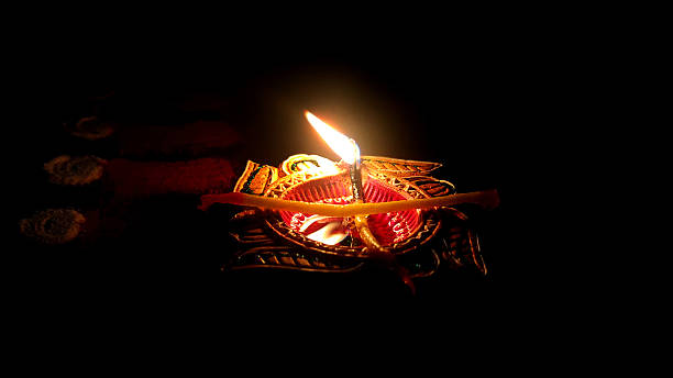 istock Single Clay Oil Lamp Glowing in Darkness 2240209894