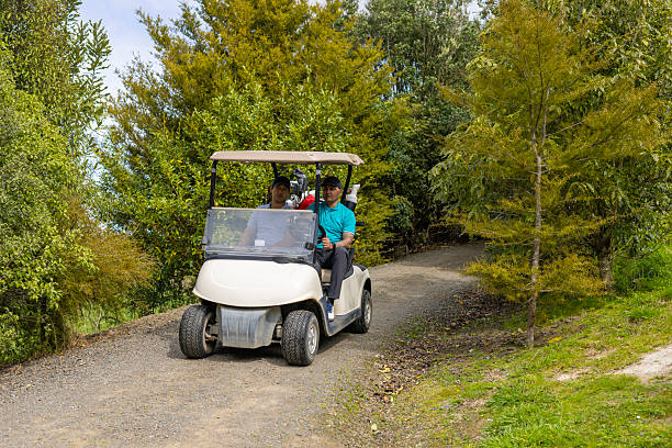 istock Asian man driving a golf cart on a golf course 2240210089