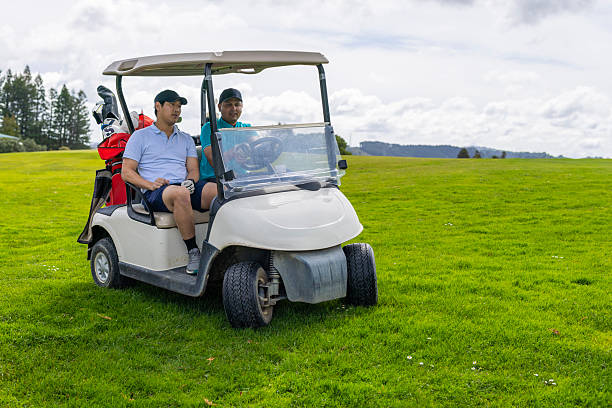 Golfcar on beautiful golf course in the evening golf course with fresh green grass field and cloud sky.