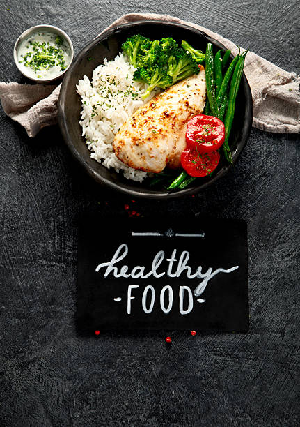 Grilled salmon with mushrooms, spinach, organic beets, salad with arugula and tomatoes and broccoli.  All ingredients in this image are considered to be very nutritious super foods.