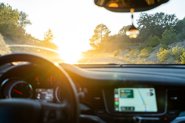 istock Driving car on road trip toward sunset 2240211382