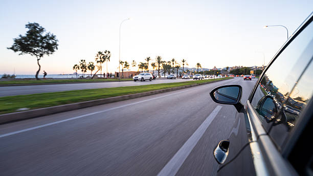 istock Driving car on coastal road during sunset 2240211388