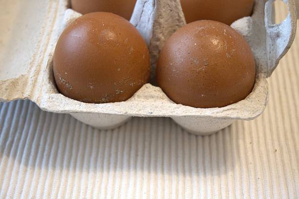istock Brown chicken eggs in paper box, close-up, copy space 2240213901