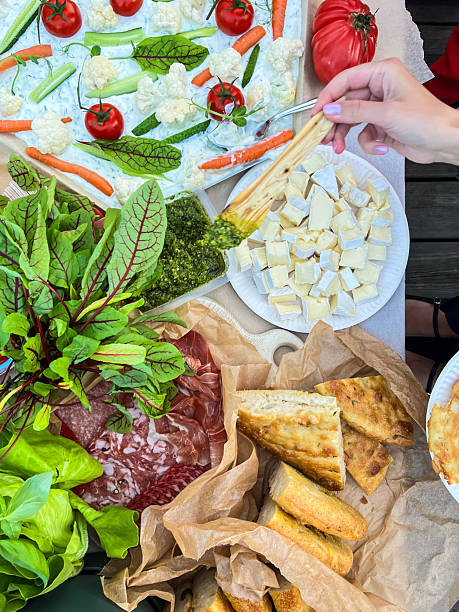 istock Fresh vegetable platter with tomatoes, carrots, and cheese on rustic outdoor table 2240215281