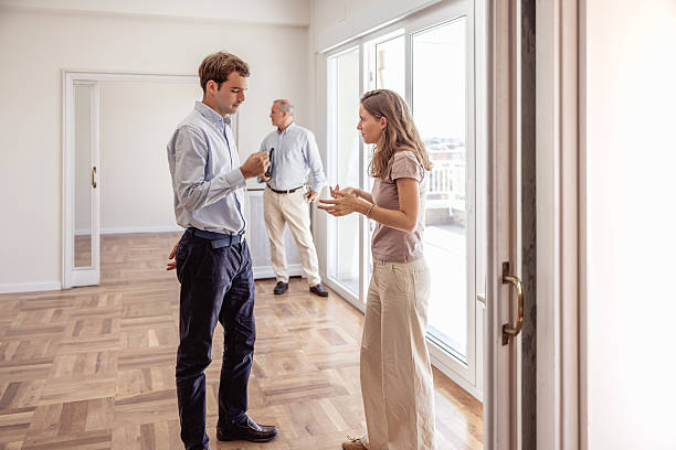 istock Young couple disagreeing with real estate agent during house viewing 2240215541