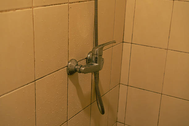 istock Chrome Shower Faucet On Beige Tiled Wall 2240216642