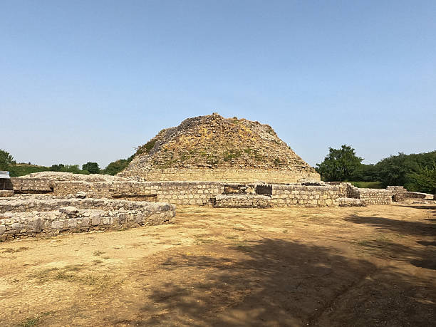 istock Dharmarajika heritage site ancient Buddhist stupa with tree standing under clear blue sky in Taxila ruins 2240216763