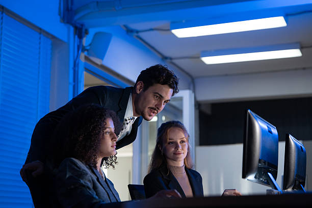 istock Manager mentoring a diverse team of female colleagues, analyzing financial data in a modern office. 2240219178