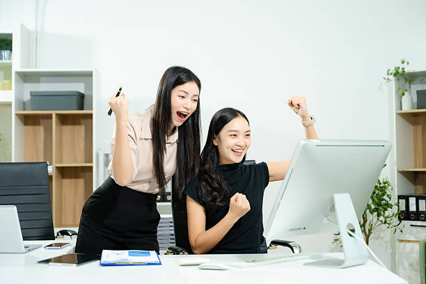 istock Happy businesspeople while collaborating on a new project in an office. Group of diverse businesspeople using a laptop and tablet in office. 2240219727