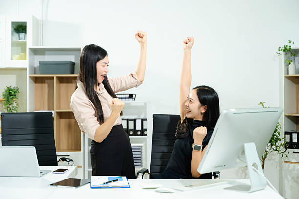 istock Happy businesspeople while collaborating on a new project in an office. Group of diverse businesspeople using a laptop and tablet in office. 2240219741
