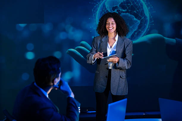 istock Confident female speaker presenting on global technology and cybersecurity at a seminar or conference. 2240219757