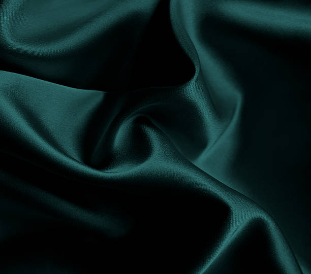 istock Luxurious cold dark blue fun british racing teal emerald green silk fabric with elegant, flowing drapes and soft sheen. Premium satin cloth texture for business. Sleek bedding, sheet. Shiny folds 2240220309