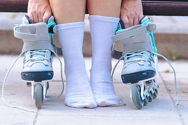 istock Roller skates on ground with person wearing socks, close up 2240221862