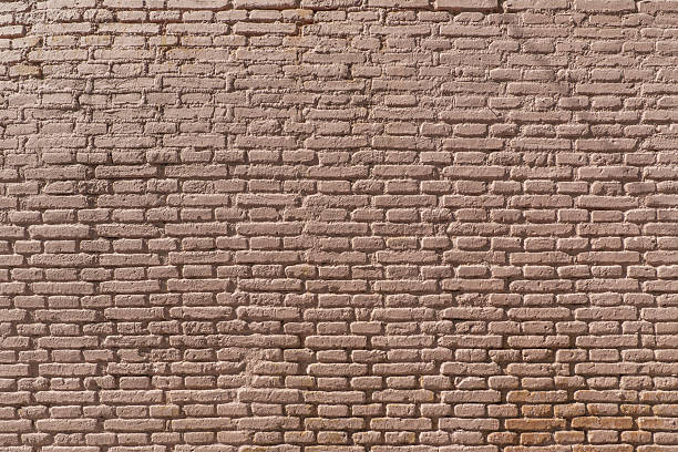 istock A wall of exposed clay bricks with light brown paint 2240222407