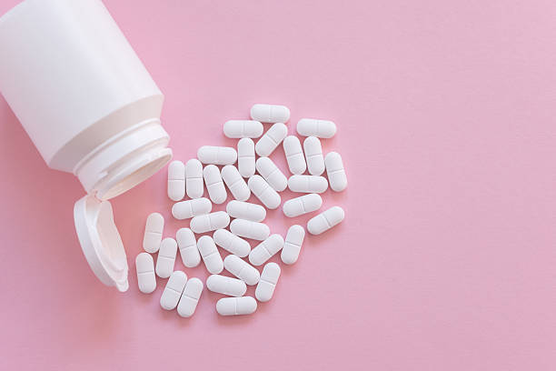 istock Tabletten or pillen in white package on the pink background with place for text. 2240224175