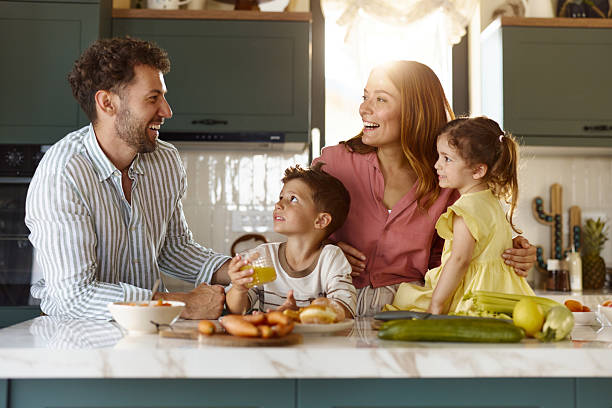 istock Happy family talking in the kitchen. 2240225831