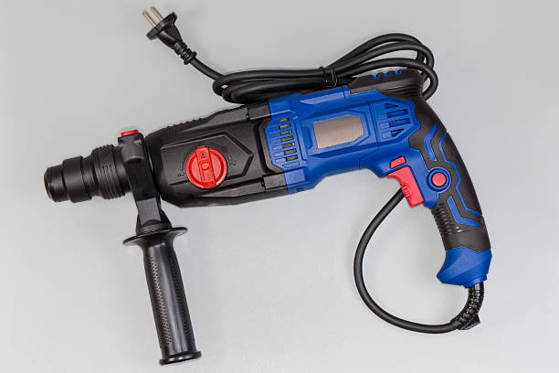 istock Electric rotary hammer drill on a gray background, side view 2240226530