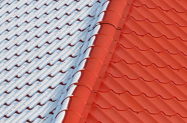 istock A red and white roof with snow on it 2240229947