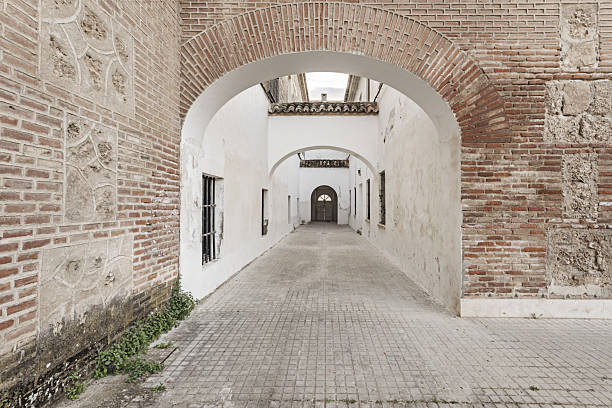 istock A passageway with whitewashed walls in a monumental building with brick facades 2240231586