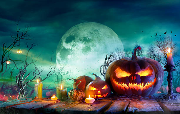 istock Halloween - Pumpkins And Candles On Table At Moonlight 2240231717