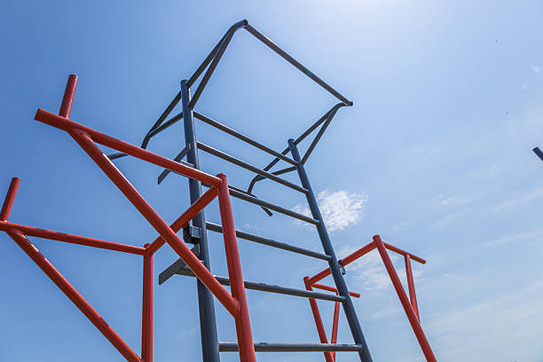 A horizontal training bar structured for fitness activities stands under a clear blue sky in a park, inviting athletes to engage in outdoor workouts
