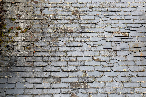 istock Old slate roof covered with moss and lichens 2240233671