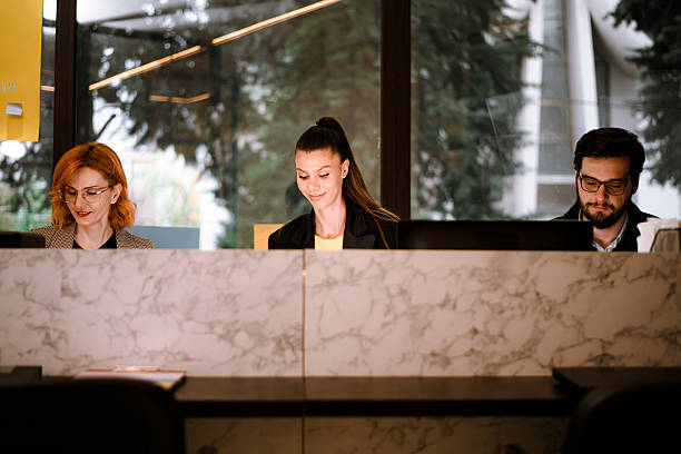 istock Three professionals working together in a modern office space surrounded by natural light and greenery during the day 2240234058