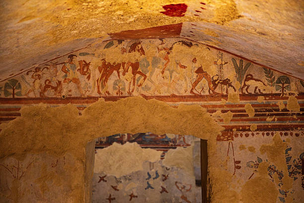 Ancient wall painting inside an Etruscan tomb in Tarquinia, Italy. This archaeological fresco, dating back to the Etruscan civilization of the 7th–3rd century BC, is part of the UNESCO World Heritage necropolis, offering a unique testimony of early Italic funerary art.