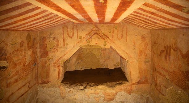 Ancient wall painting inside an Etruscan tomb in Tarquinia, Italy. This archaeological fresco, dating back to the Etruscan civilization of the 7th–3rd century BC, is part of the UNESCO World Heritage necropolis, offering a unique testimony of early Italic funerary art.