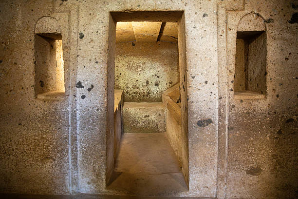 View of the Inside of Etruscan necropolis of Cerveteri (Banditaccia), an ancient burial site dating back to the 9th–3rd century BC. The archaeological area features grass-covered tomb mounds and rock-cut chambers, representing one of the most important remains of the Etruscan civilization in central Italy.